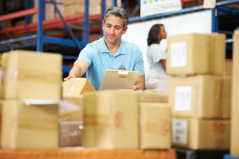 Workers In Warehouse Preparing Goods For Dispatch - IMA